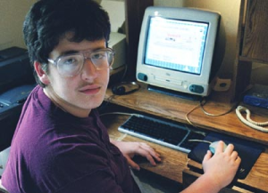 Young man using a computer in his home.